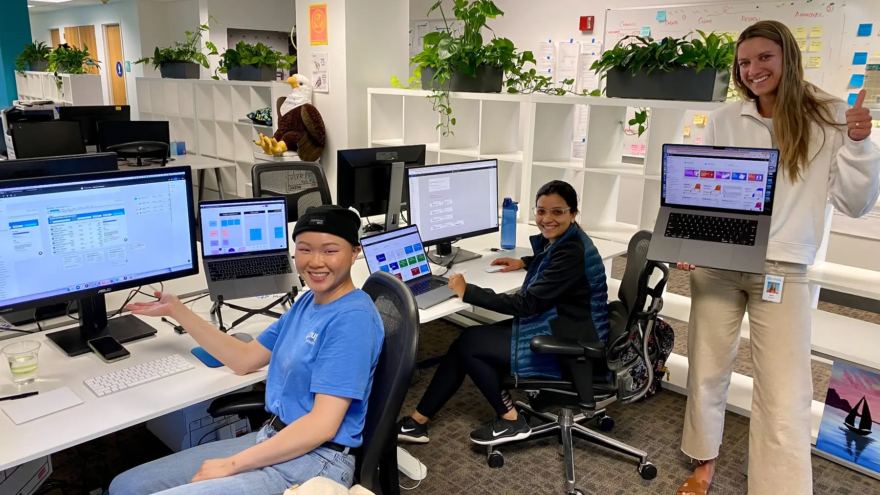Sara collaborating with two designers in the Coupa office