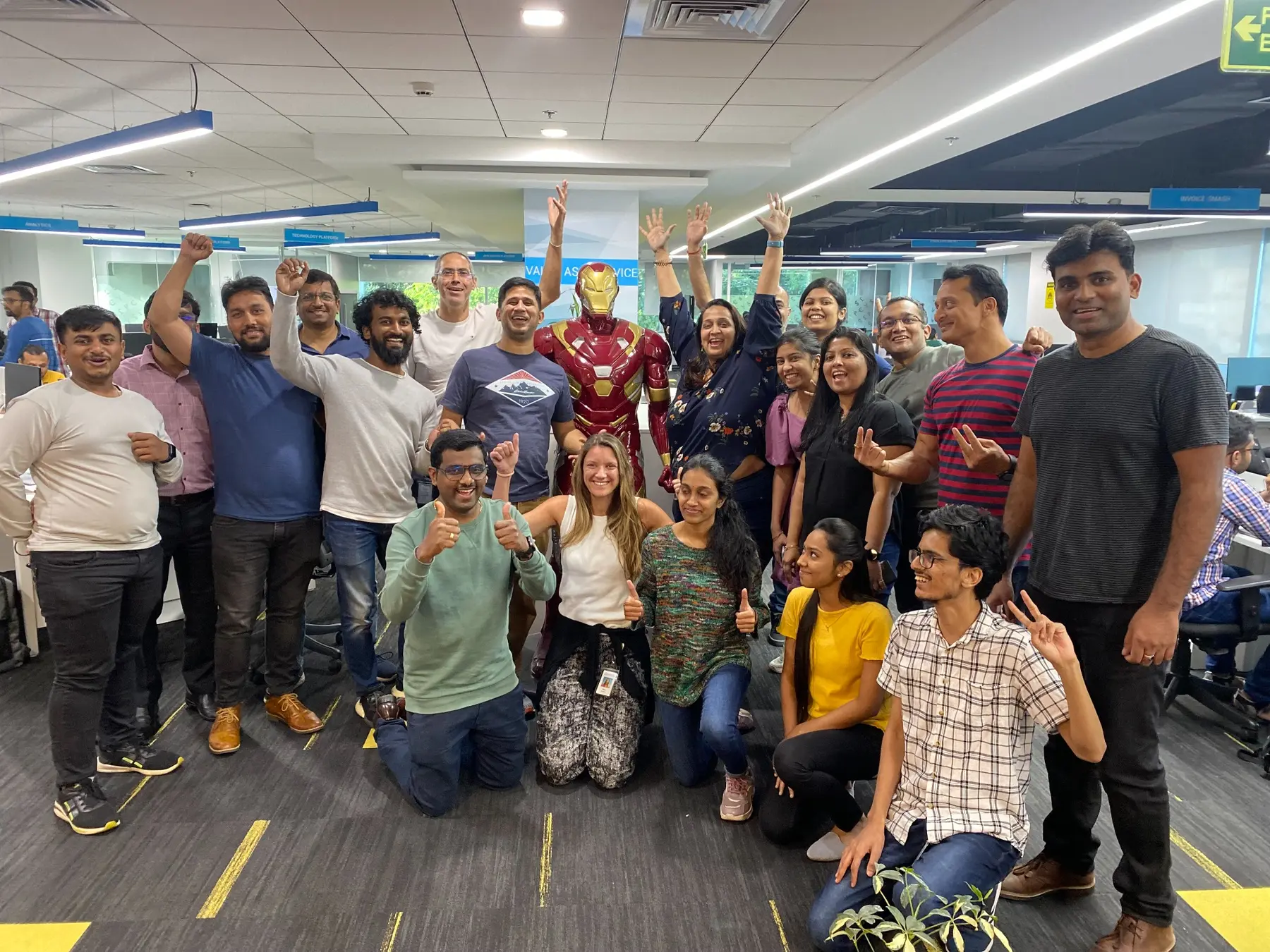 Sara and a large group of Coupa colleagues smiling together in India